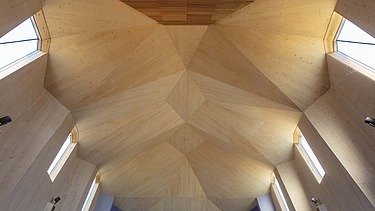 Photo of the interior of a chapel with a large vaulted wooden ceiling