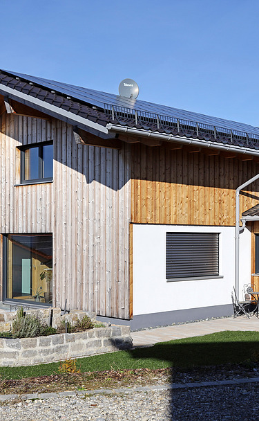 Ebersbach residential building Photo of a residential building made of LENO cross-laminated timber with a timber rendered façade.