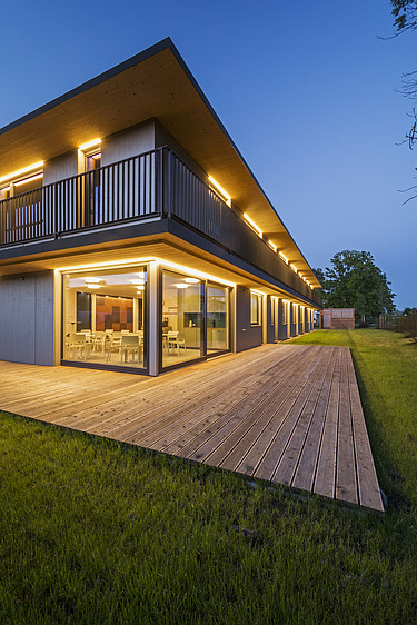 Photo of the law firm FGS Augsburg. Modern wooden building with flat roof and spacious wooden terrace