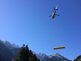 Foto der Holzbaumontage des Waltenberger Haus in Oberstdorf. Helikopter-Montage der LENO-BSP-Elemente.