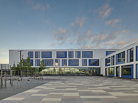 Photo of an exterior shot of a school with white façade elements