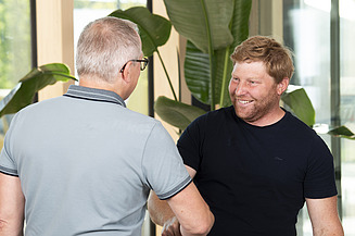 Photo of two men shaking hands.
