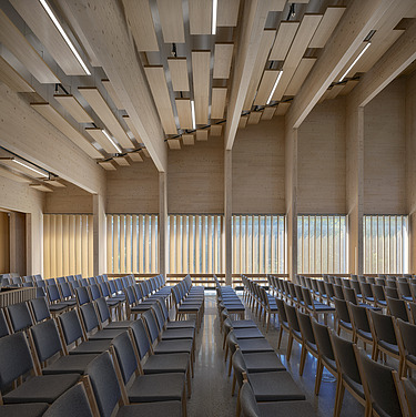 Photo of the interior seating of the Tau Kirke in Norway. You can see the wooden skeleton structure of the ceiling and wooden elements on the wall.