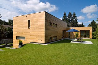 Photo of a modern LENO wooden house with wooden façade.