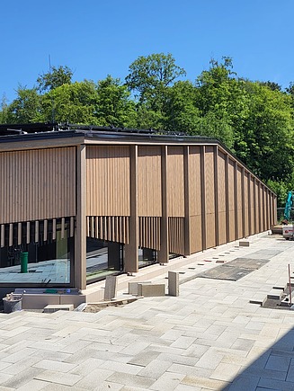  pilaster strips running the full height of the building, made from pre-weathered spruce glulam, complete the look. 