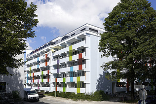 Photo of a multi-storey building with a white and colorful façade.