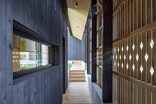 Photo of a modern wooden house with wooden facade. Detail picture facade.