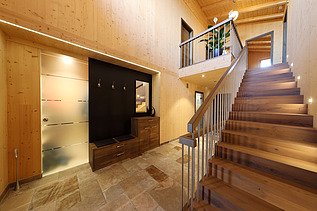 Photo of a residential building made of LENO cross laminated timber. Staircase with many wooden surfaces.