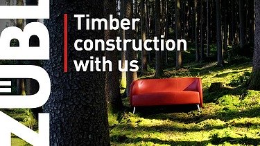 Photo of a red couch standing in the forest. Cover image of the ZÜBLIN Timber image film.