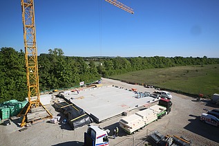 Construction site photo. Truck brings the first cross-laminated timber elements.