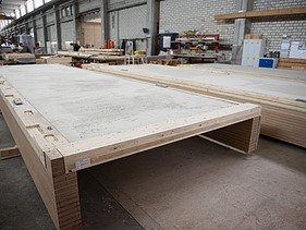 Photo of a horizontal rib element in the ZÜBLIN Timber production hall.