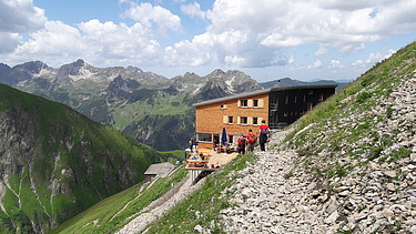 Photo of the Waltenberger Haus in Oberstdorf. Wooden building at an altitude of 2,085 meters.