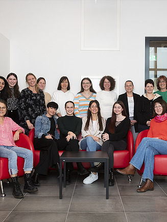 Photo of many female colleagues from ZÜBLIN Timber smiling at the camera.