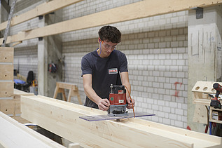 Sebastian cutting the material.