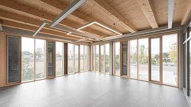 Photo of the Flexim Berlin shell from the inside. Can be seen: Wooden ceiling and façade.