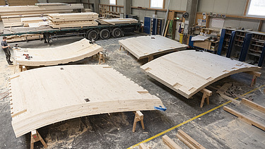 Photo of LENO cross-laminated timber elements in the ZÜBLIN Timber production hall.