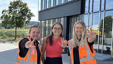 Photo of three young women standing in front of the new ZÜBLIN Timber office building.