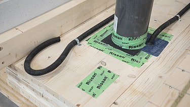 Foto eines Detailausschnittes einer LENO-ADD-Wand. Man sieht ein Rohr und Elekrovorkehrungen.