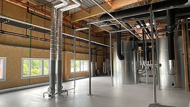 Photos of a storage room with timber frame walls.