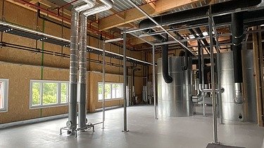 Photos of a storage room with timber frame walls.