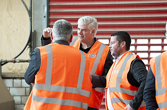 Three men in orange high-visibility waistcoats. Stefan Kratochwill in the centre.