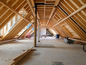 Foto des Rohbaus VINZENT in München. Zu sehen ist der Dachstuhl aus Holz.