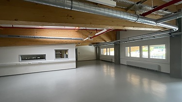 Photo of a large, bright storage room that is empty.