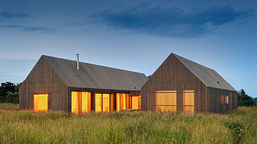 Photo of a modern wooden house in U-shape with wooden facade. LENO-BSP.