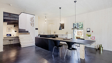 Photo of a modern dining room with visible LENO CLT walls and ceiling.