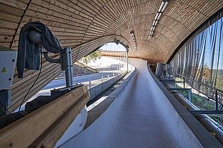 Photo of a toboggan run. You can see a wooden roof and only a section of it