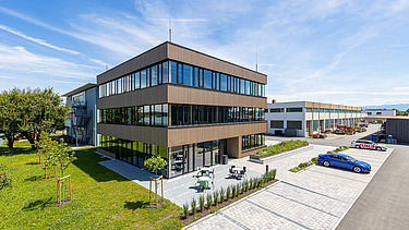 Photo of a timber building with timber and glass façade and flat roof.