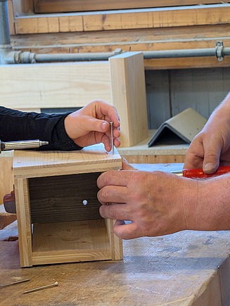 Support with the construction of a bird house. 