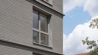 Foto der Joseph-Stiftung in Bayreuth. Man sieht ein Gebäude mit grauer Fassade.