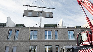 Foto der Montage von LENO-ADD-Holzbauelementen, auf der Baustelle Quartier Hangweide in Kernen