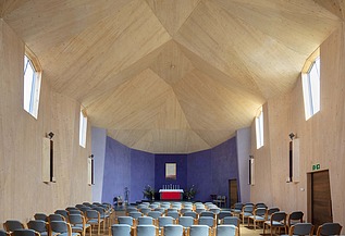 Photo of the interior of a chapel with a large vaulted wooden ceiling