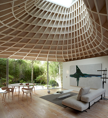 Photo of a living room with an eye-catching, curved wooden ceiling