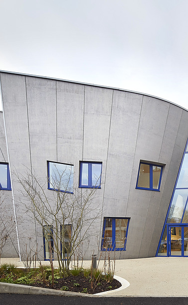 Maggies Center London Photo of a building with a wooden façade and sloping walls
