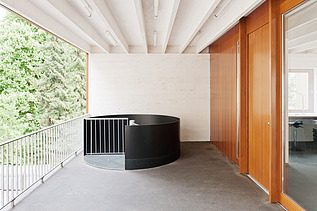 Photo of a balcony with visible, white ribbed wooden ceiling. Wooden extension.
