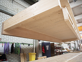 Photo of a floating rib element on the crane in the ZÜBLIN Timber production hall.