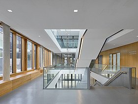 Interior photo of the Munich North Grammar School. You can see a corridor area and the timber mullion and transom façade.