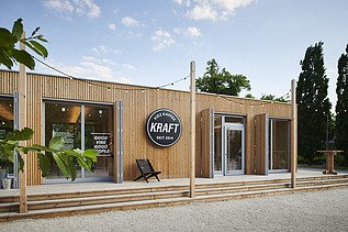 Photo of a wooden building with flat roof and terrace.