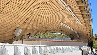 Photo of a toboggan run. You can see a wooden roof and only a section of it