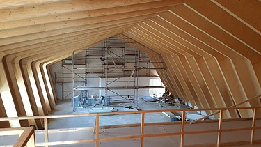 Foto der Montage der Metropolitan School Berlin. Zu erkennen sind viele Holzelemente.