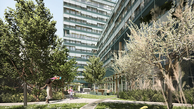 Photo of the new UmweltHaus in Nuremberg. You can see a large building and trees.