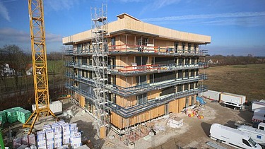 Foto eines mehrgeschossigen Holzbaus während der Montage.