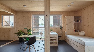 Photo of the Collegium Academicum in Heidelberg. You can see a furnished room with many wooden surfaces.