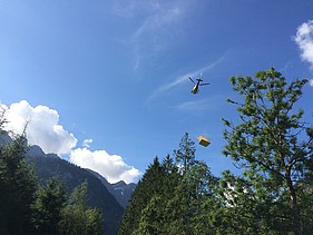Photo of the timber construction assembly of the Waltenberger Haus in Oberstdorf. Helicopter assembly of the LENO CLT elements.