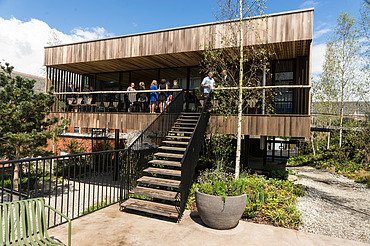 Maggies Center Oldham Photo of a wooden building with flat roof and large staircase.
