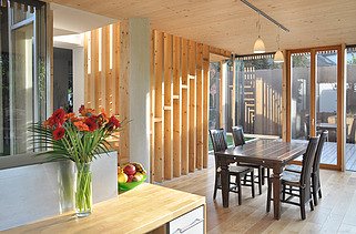 Photo of a timber house with flat roof. LENO-BSP. Detailed picture of dining room.