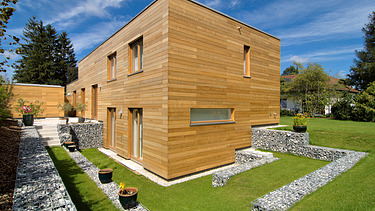 Photo of a modern LENO wooden house with wooden façade.